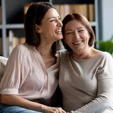 2 vrouwen lachen in een zetel